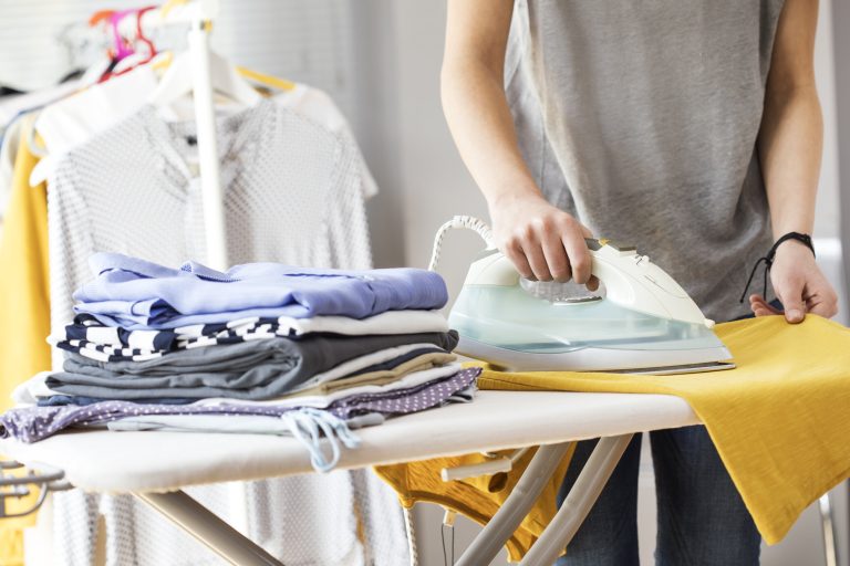 Ironing clothes on ironing board